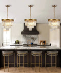 Gold Crystal Chandelier 16 Inch Modern Ceiling Pendant Light Fixture Dimmable Flush Mount Round Chandelier For Dining Room Kitchen Island Foyer Entryway Living Room Totally Chic Glam Glow shown above a kitchen island.