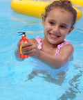 Girl in pool holding a red mini fire extinguisher water squirt gun, part of a twelve piece set for kids summer fun.