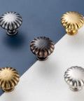 Assorted metal cabinet knobs on split background showcasing Antique Brass Cabinet Knobs One And A Quarter Inch Ten Pack Single Hole Drawer Pulls For Kitchen Cabinets Dressers Desks Bedroom Vanities Cupboards And Bathrooms Durable Rust Resistant Metal Hardware