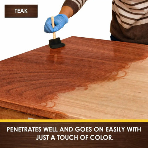 Person using Hella Fast Drying Water Based Wood Stain With A Slick Matte Finish on teak wood table surface.