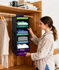 Multipurpose Hanging Closet Rack With Five Built In Dividers Weekly Garment Sorter Space Saving Home Organizer that is being used to sort kids clothes.