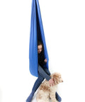Blue 95 Percent Cotton Sensory Swing For Kids X Large Therapy Swing With Deep Pressure Support For Autism SPD And Anxiety Calming Cozy Swing With 4 Way Stretch Fabric Hardware Included, girl inside with dog