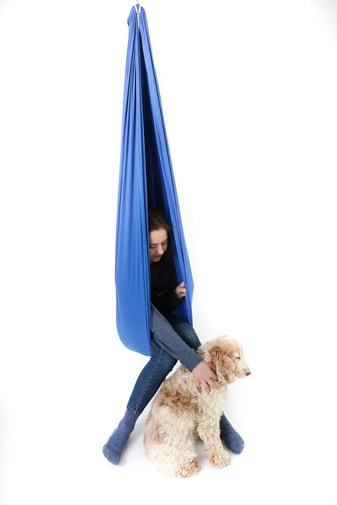 Blue 95 Percent Cotton Sensory Swing For Kids X Large Therapy Swing With Deep Pressure Support For Autism SPD And Anxiety Calming Cozy Swing With 4 Way Stretch Fabric Hardware Included, girl inside with dog