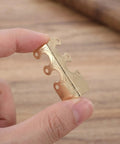 Golden piece from Retro Metal Corner Protectors 20 Pack For Boxes And Wooden Cases Old School Charm edge detail.