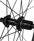 Close-up of rear hub showing details of Carbon Disc Wheelset 50C Tubeless Center Lock With Front 12x100 And Rear 12x142 Thru Axles Black Finish