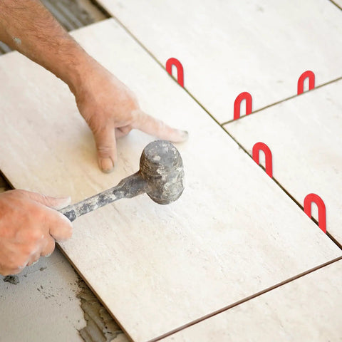 Installation of tile using red 1/8 inch 1200Pcs Horseshoe Shims Set Plastic Leveling Spacers For Tile Windows And U Shims