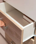 Pack Of Eight Clear Glass Table Bumpers With Solid Stems And Grippy Non Slip Bottoms That Slide Right Into Quarter Inch Holes on a cabinet drawer.
