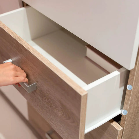 Pack Of Eight Clear Glass Table Bumpers With Solid Stems And Grippy Non Slip Bottoms That Slide Right Into Quarter Inch Holes on a cabinet drawer.