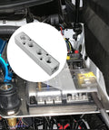 Four Way Pneumatic Manifold Aluminum Alloy Air Distribution Block next to an engine bay, showcasing G1/2 inlet and G1/4 outlets.