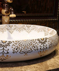 Slick Oval Ceramic Bathroom Sink For Countertop Vanity Rock Solid Above Counter Style With Pop Up Drain No Overflow Easy Setup Knockout Look For Small Half Baths And Daily Home Refreshers with gold floral design on white surface.