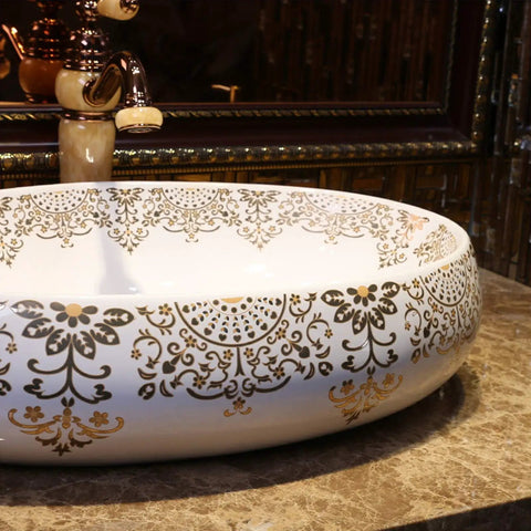 Slick Oval Ceramic Bathroom Sink For Countertop Vanity Rock Solid Above Counter Style With Pop Up Drain No Overflow Easy Setup Knockout Look For Small Half Baths And Daily Home Refreshers with gold floral design on white surface.