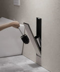 Hidden In Wall Toilet Brush Holder Cabinet in matte black with tileable door, recessed niche storage, showing brush access, 45x12x12 cm
