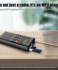 Pocket Mini FM Radio And MP3 Player With USB TF Card Support showing frequency range and USB input on wood surface.