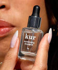 Instant Smudge Fix For Nails Smooths Dents And Imperfections Quick Dry Top Coat Booster displayed in hand with long nails.