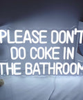 White neon LED sign with text 'Please Don't Do Coke In The Bathroom' on a white background.