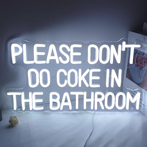 White neon LED sign with text 'Please Don't Do Coke In The Bathroom' on a white background.