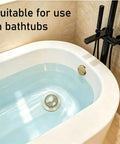 No Fuss Tub Drain Overflow Kit With Smooth Pop Up Stopper And Nifty Copper Hair Catcher Basket To Ban Clogs Quick Install in a modern bathtub.
