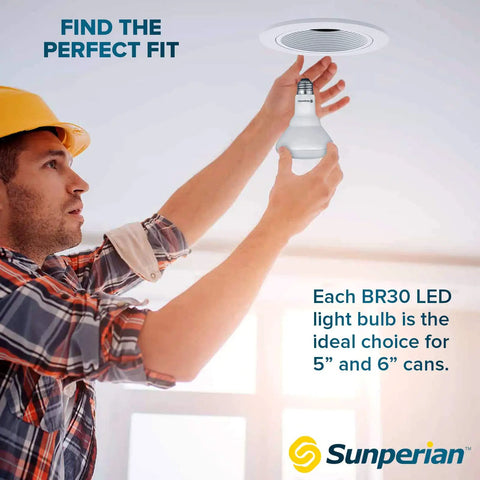 Person installing Brighten Your Home With 8.5W BR30 LED Flood Bulb in ceiling recessed can lighting, 800 Lumens, 3500K