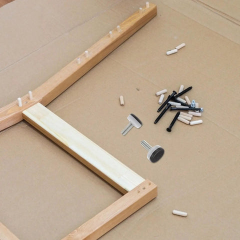 Adjustable M10 Furniture Leveling Feet Set With ABS And Iron Inserts 30 Pack displayed with wooden frame assembly tools