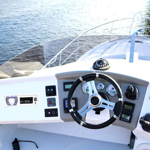 Dashboard with Bluetooth Marine Receiver Stereo 12V Single DIN In Dash Boat Radio, digital LCD on a boat with steering wheel.