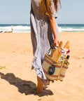 Woman on beach with Clip 4 Portable Mini Bluetooth Speaker with Carabiner IP67 Waterproof and Dustproof Design in woven bag