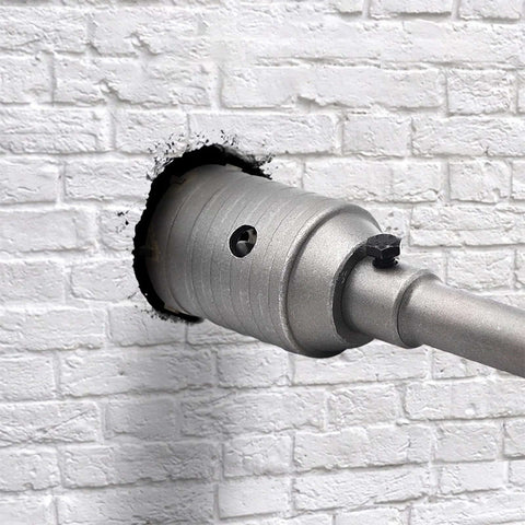 2-1/2 inch concrete hole saw with 65mm wall drill bit on a metal shank, installed in white brick wall
