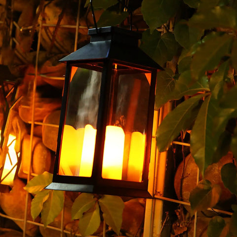 2-Pack Solar Lanterns For Outdoor Garden Hanging Lights 11.8 Inch Flickering Flameless Candles illuminating among plants at night