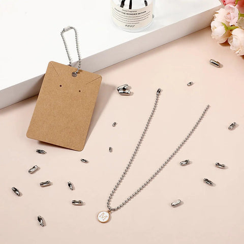 50 Pcs Silver Tone Stainless Steel Ball Chain Connectors And Clasps Set for 4.5mm Ball Chain on desk with card and beads