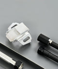 Mailbox Roller Catch Kit For Cabinet Doors And Drawers with iron construction and screws on a gray surface