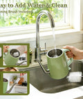Gooseneck Electric Kettle 0.8L With 1200W Quick Boil, Stainless Steel, Auto Shut Off, Precision Pour Over Kettle For Coffee Nerds And Tea Lovers, Perfect For Small Kitchens, RVs And Travel, Green being filled with water at a kitchen sink with included cleaning brush.