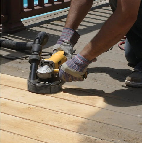 Person using Wood Deck Removal Tool Four And A Half Inch For Fast Coating Prep with metal dust shroud on deck surface.