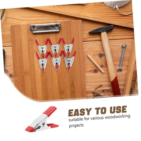 12 Pack Heavy Duty Metal Spring Clamps Kit For Woodworking Pros And DIY Gurus Offering Insane Grip Power For Crafts Dress Fitting Garlands And Household Projects You Need Right Now, red metal spring clamps on wood board