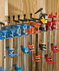 Heavy Duty Wall Mounted Pipe Clamp Rack That Keeps Clamps In Line Built From Galvanized Steel Holds Nine Pipe And Bar Clamps Up To 0.30 Inches Wide Organizes Your Workshop And Frees Up Space Like A Boss, pictured with clamps mounted.