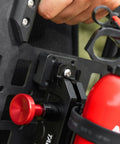 Close-up of Universal MOLLE Mounting Bracket Base securing a fire extinguisher holder to a panel with MOLLE slots.