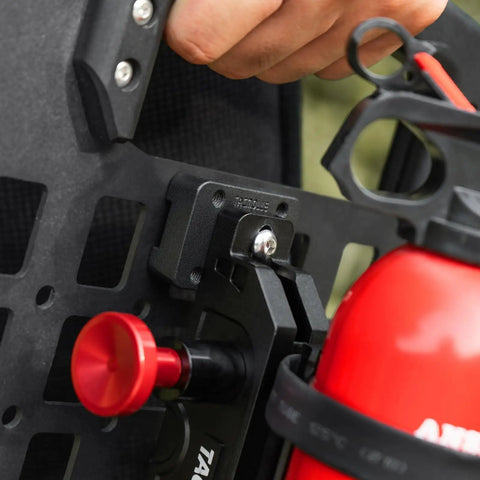 Close-up of Universal MOLLE Mounting Bracket Base securing a fire extinguisher holder to a panel with MOLLE slots.