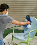 Person using Quick Finish HVLP Paint Sprayer for Crafting and Furniture on a chair, showcasing adjustable spray settings.