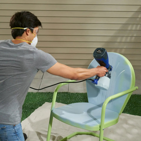 Person using Quick Finish HVLP Paint Sprayer for Crafting and Furniture on a chair, showcasing adjustable spray settings.
