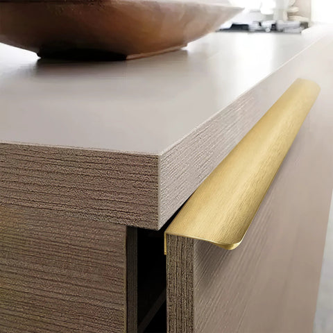 Edge Finger Pulls For Cabinets And Concealed Drawers, Aluminum Long Handle Hardware In Brushed Brass Finish, mounted on drawer.