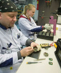 Technicians assembling Advanced Mirror Compass For Pros And Serious Hikers With Metric UTM Scales And Inch Ruler in factory