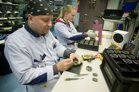 Technicians assembling Advanced Mirror Compass For Pros And Serious Hikers With Metric UTM Scales And Inch Ruler in factory