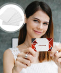 Twenty Piece Bundle Of Slick Blank White Pvc Id Cards With Heavy Duty Waterproof Coating And Hassle Free Printing For Quick Employee Badges And Double Sided Photo Cards In Sharp Resolution held by a smiling woman.