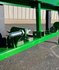 Close-up of No Hassle Dual Mount Tractor Pallet Forks for Front Loader with secure mounts and bright green finish.