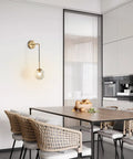 Mid Century Modern Wall Light With Adjustable Cord Raw Brass Round Glass Sconce And Amber Lampshade in dining room