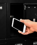 Built Different 12 Door Tablet And Cell Phone Locker featuring keyed differently locks with someone placing a smartphone inside.