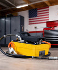High-Pressure Air Hydraulic Pump Kit With 10,000 PSI Power, 0.6 Gal Reservoir, Foot Pedal Operation, 6.6 Ft Hose And Spray Gun, NPT Three-Eighth Inch Outlet And One-Quarter Inch Inlet, Yellow Built-To-Last Workhorse For 10-Ton Jobs, in workshop