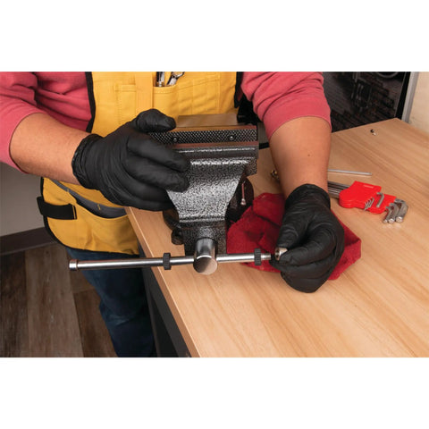 Person using Hammer Tough 8 Inch Bench Vise with powder coated finish, 360 degree swivel base, 7 inch jaw opening in a workshop.
