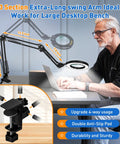 Man using Beefy Long Reach 12X Magnifying Glass With Light And Stand, Three Section Swing Arm Extends To Over 42 Inches clamp