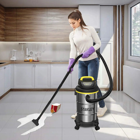 Woman cleaning kitchen floor with Beast Mode Suction 4 Peak HP Shop Vacuum Wet Dry 5 Gallon With Stainless Steel Drum 85 CFM