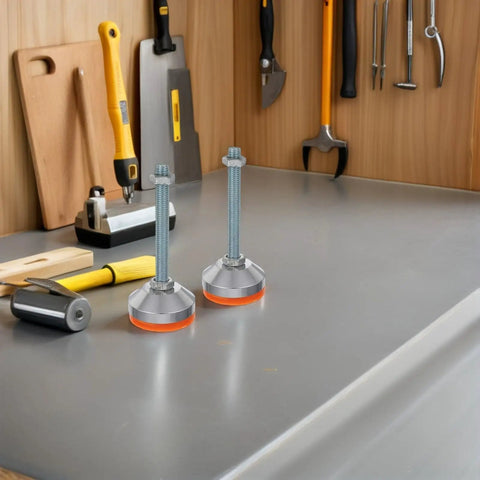 Heavy Duty Swivel Leveling Feet With GripLock Rubber Base And Easy Tune Bolts For Sturdy Workbenches And Garage Rigs D60x12mm Pack Of Two on workbench with tools.