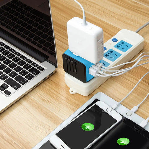 Worldwide Travel Adapter With 2.4 Amp USB Charging And 3 USB A Ports Plus USB C Fast Charge Universal Wall Charger plugged into power strip